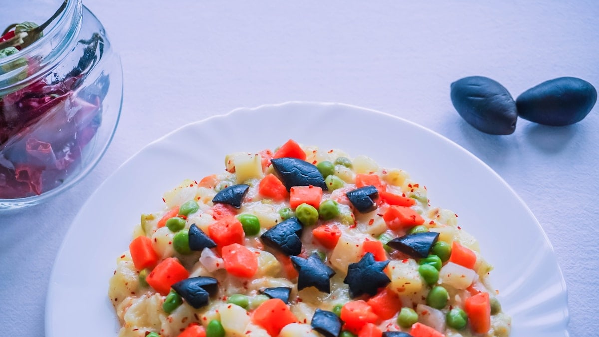 Colorful vegetables on a white plate, shaped in stars, hearts, and diamonds.